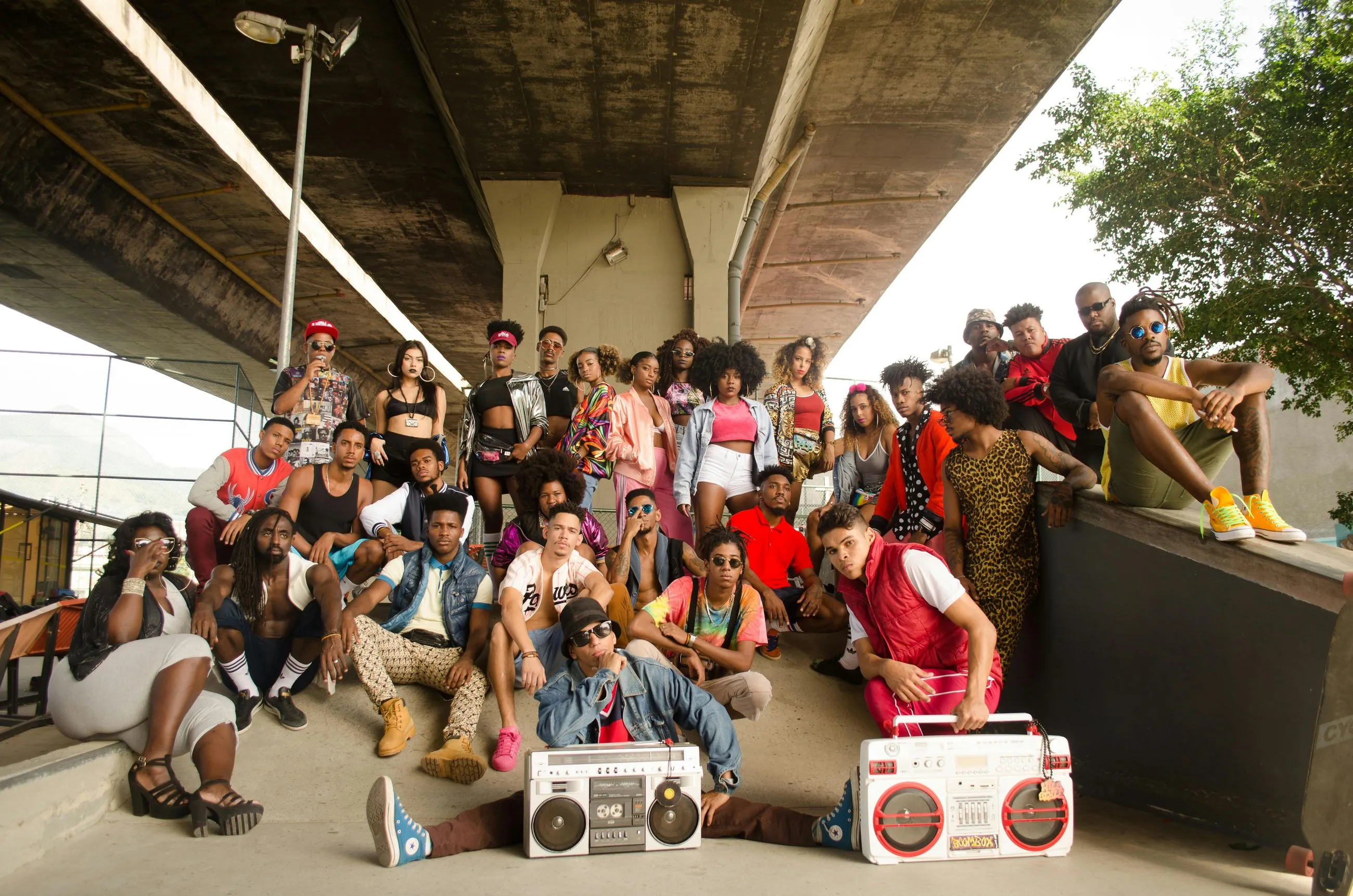 Large group posing under bridge in retro fashion