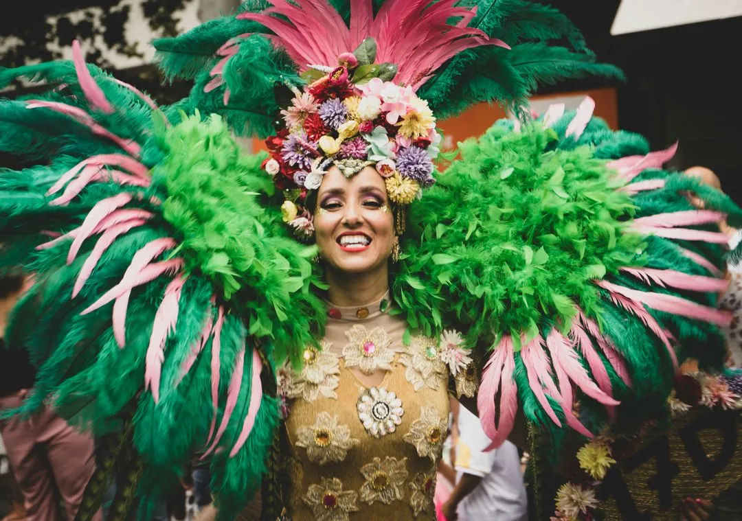 Smiling woman in feathered carnival costume